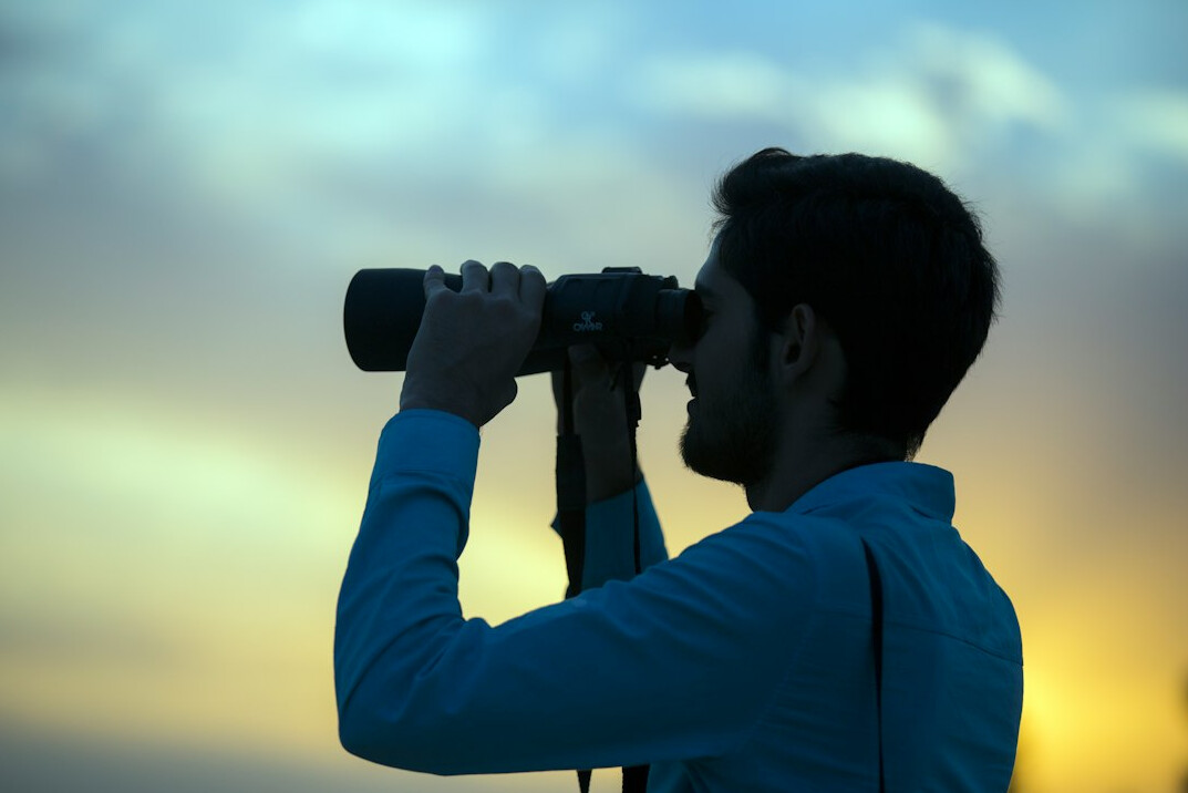 man using binoculars